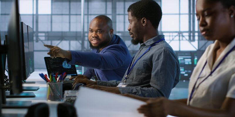 Data center engineers maintaining company network infrastructure by installing, configuring, troubleshooting and repairing hardware. Server hub workers ensuring optimal system performance, camera A