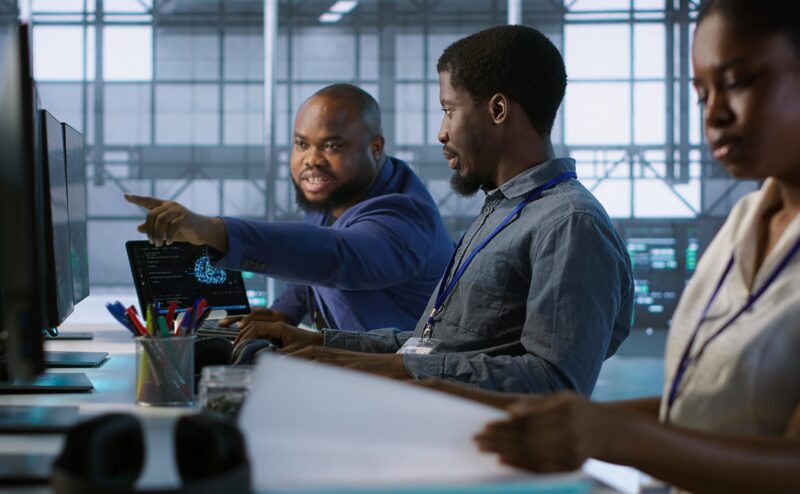 Data center engineers maintaining company network infrastructure by installing, configuring, troubleshooting and repairing hardware. Server hub workers ensuring optimal system performance, camera A